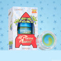 ColourPop Lip Mask The Chosen One sits in a Toy Story Pizza Planet rocket box with green alien art, showing the Sour Candy jar and an open pot revealing a blueโgreen swirl balm, 8 g (0.28 oz), against a blue sheriffโstar patterned background.