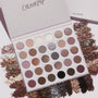 Stone Cold Fox ColourPop Shadow Palette lying open, displaying 30 coolβtoned neutral eyeshadows in matte and shimmer finishes; taupe, mauve, gray and champagne pans ringed by crushed powder swatches on a light backdrop.