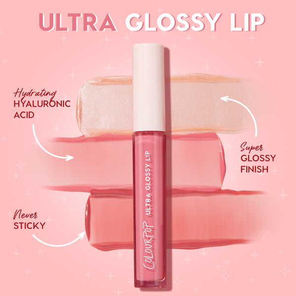 ColourPop Ultra Glossy Lip tube from the Dream Duo Ultra Lip Duo rests over pearly nude and rosy pink swatches, showcasing hydrating hyaluronic acid with a super glossy, never-sticky finish on a pink backdrop; ColourPop Ultra Lip Duo.