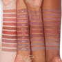 Ashton ColourPop Lippie Pencil swatched on three forearms, a mid‑tone nude brown stripe labeled “ASHTON” among other shades, showing smooth matte payoff and how the lip liner appears on light, medium, and deep skin tones.
