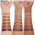 Moonstone Beach ColourPop Bronzer Stix swatch shown on three arms with varying skin tones, displaying a medium warm-neutral bronze with creamy, blendable payoff; positioned between La Jolla Cove and Rincon Point in the shade range.