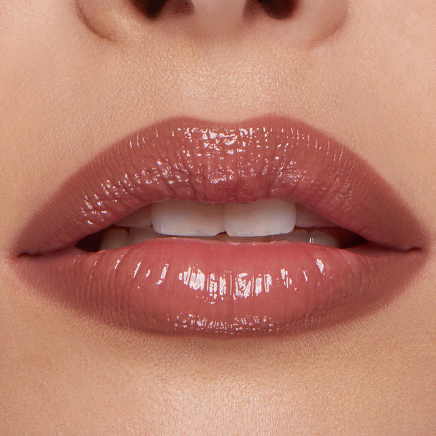 Glossy rosy nude lips wearing the Go-To Lip ColourPop So Juicy Plumping Lip Liner & Balm Set, showing smooth definition and fuller-looking shine in a tight, close-up beauty shot.