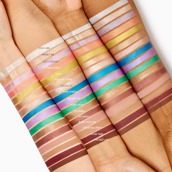 Friday Feels Shadow Stix swatch - one creamy, shimmery stripe - glides across multiple forearms of different skin tones, shown alongside the full ColourPop Shadow Stix lineup to demonstrate pigment payoff and blend in bright studio lighting.
