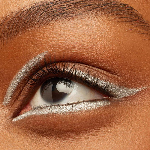 Metallic silver graphic wing defines a close-up eye, created with ColourPop Crème Gel Liner Kicker, tracing the inner corner, lower lash line, and a floating crease for a bold, long-wearing look from the creamy, smudge-proof formula.