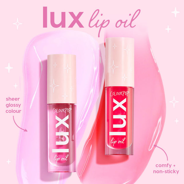 Two ColourPop Lux Lip Oil Top Hits tubes stand side by side, showing sheer glossy color and a comfy, non-sticky formula, with soft pink and bright fuchsia swatches on a pastel pink backdrop for hydrating shine.