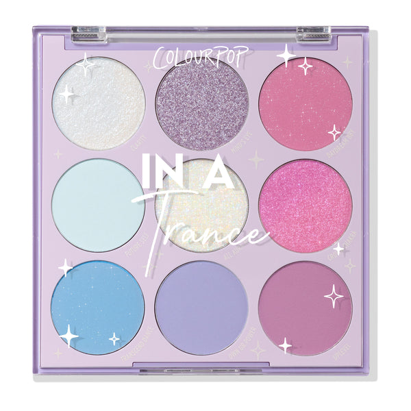 ColourPop Shadow Palette In A Trance showcases nine pastel pans - white shimmer, lilac glitter, pink shimmer, mint, iridescent, hot pink, sky blue, periwinkle, and mauve - arranged 3x3 in a lavender compact with clear lid and star accents.