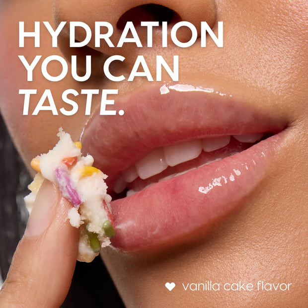 ColourPop Lip Scrub in Vanilla Cake flavor, a sprinkle‑studded sugar exfoliant, being applied with a fingertip to glossy lips, revealing soft hydration in a tight close‑up product shot.