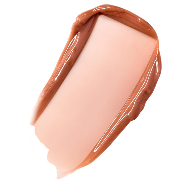 Glossy caramel nude balm swatch spreading in a smooth, high-shine swipe on white, showcasing ColourPop Fresh Kiss Glossy Balm in Caramel Latte, a sheer warm beige with a latte tint.