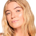 Model wearing Gloss Goals from the ColourPop Full Collection Set shows a sheer, high-shine glossy balm on lips in a close-up, with dewy skin and natural lashes against a white background, spotlighting the hydrating, glassy finish.