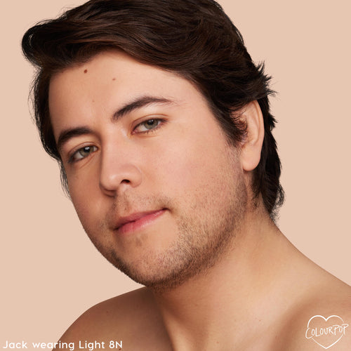 Model wearing ColourPop Pretty Fresh Tinted Moisturizer in Light 8 N shows natural, light coverage and a smooth, skin-like finish; close-up face angled left against a neutral peach background highlighting even tone.