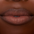 Close-up lips wearing ColourPop Ultra Blotted Lip in Espresso Martini, a coffee-brown shade with a soft-matte, blotted finish and gently diffused edges, shown in studio lighting to showcase the lightweight, blurred-effect formula.