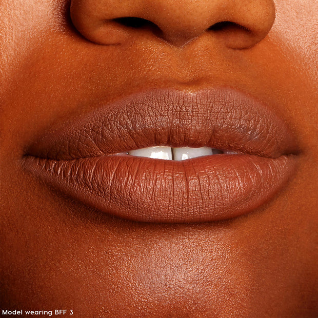 Lips lined and filled with ColourPop Lippie Pencil in BFF 3, showcasing a warm brown matte finish; close-up swatch for The Lil Box of Lippie Pencils under studio lighting, highlighting smooth texture and precise outline.