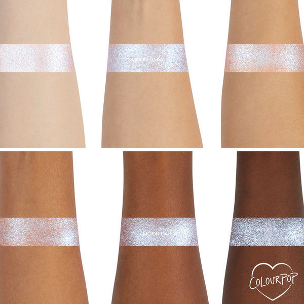 ColourPop Moon Daisy Super Shock Shadow swatches showing a high-shine icy lavender-blue shift across six arms from light to deep skin tones, demonstrating smooth metallic payoff and sparkle; ColourPop heart logo in the bottom right.