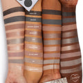 ColourPop Of Quartz Shadow Palette swatches span three arms, showing cool‑toned taupe, gray, and metallic neutrals - Rock On, Opaque, Granite Access, Magmatic, Ore, Transform, In the Zone, Sio, Mine Games - with the palette corner visible.