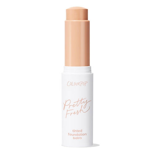 ColourPop Pretty Fresh Tinted Foundation Balm in Fair 4 stands open as a twist-up stick, revealing a light neutral-beige balm; sleek white tube with peach lettering on a clean white background.