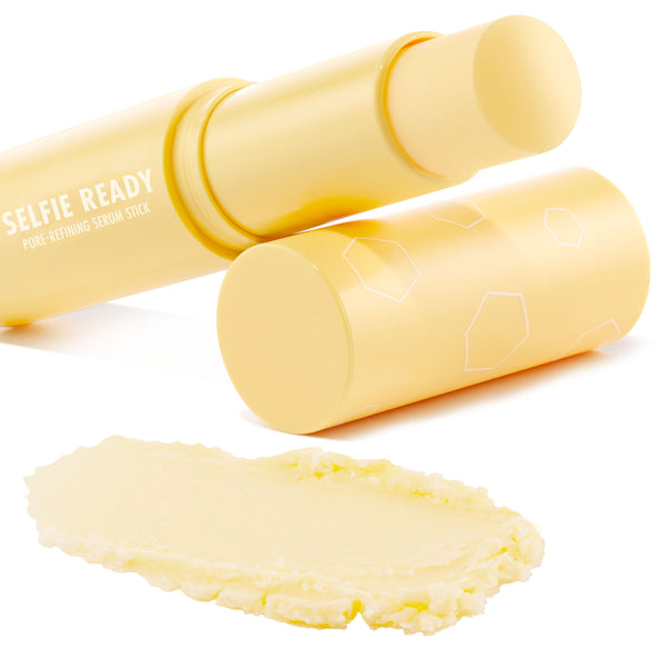 Selfie Ready pore-refining serum stick opened with twist-up balm extended, creamy pale-yellow swatch below; matte pastel-yellow tube with white geometric accents on a clean white backdrop, highlighting the ColourPop Serum Stick.