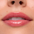 Lips wearing Experiment 626, the ColourPop Ultra Glossy Lip, gleaming with a high-shine sheer rosy pink finish in a tight close-up studio swatch, emphasizing smooth texture and natural lip lines.