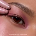 Close-up macro of Love at First Swipe Shadow Stix cream eyeshadow applied on medium skin tone, shimmery pink and berry shades, from ColourPop's Love That For Me Valentine's Day collection.