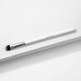 ColourPop Medium Shader Brush with flat oval, dual-toned black-to-white synthetic bristles and a silver ferrule on a white handle, resting on a white textured platform in studio lighting; makeup brush for precise eyeshadow packing and blending.