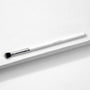 ColourPop Blending Brush makeup brush resting diagonally on a white textured surface, featuring fluffy angled black-to-white bristles, a silver ferrule, and a slim white handle, made for seamless eyeshadow blending.