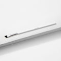 ColourPop Angled Eye Brush resting diagonally on a white textured block, featuring slim angled black bristles, a silver ferrule, and a long white handle - makeup brush for precise eyeliner and brow shaping.