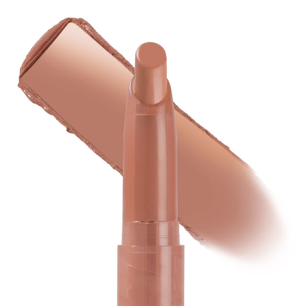 ColourPop Lippie Stix In the Nude stands uncapped with its rounded tip exposed, a wide nude‑beige swipe behind it showing smooth, creamy color payoff and coverage, set against a clean white background.