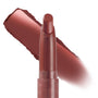 ColourPop Lippie Stix In the Nude twisting up to reveal a warm rosy-brown nude bullet, with a creamy swatch streaked behind on white, showcasing the slim retractable tube and satin finish.