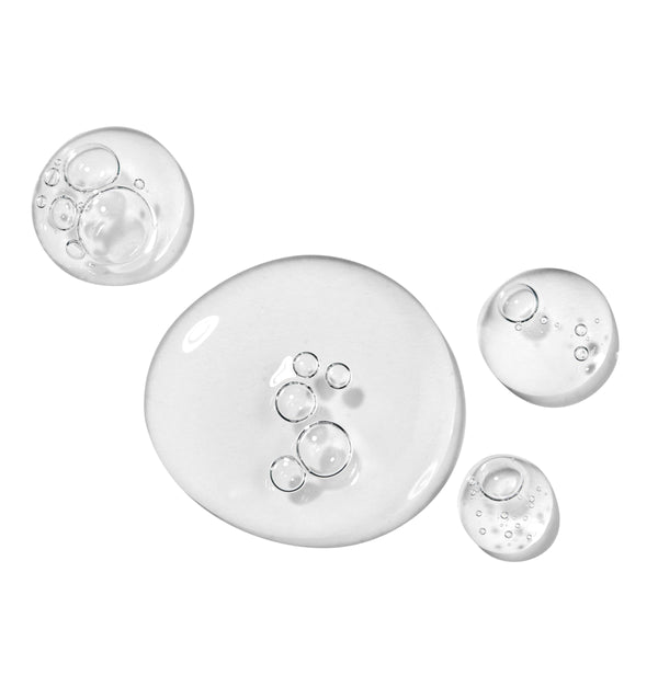 Clear gel serum swatches with suspended microbubbles show the texture of All Clear Purifying Serum, a ColourPop Face Serum, pooling in glossy droplets on a white studio backdrop.