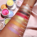 So Quiche Super Shock Shadow swatched on a forearm - shimmery olive-taupe with a green-gold shift - shown beside labeled swatches and open white pots of other ColourPop eyeshadows on a pink backdrop.