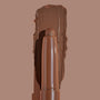 Walnut Ave ColourPop Shadow Stix sweeping a thick, matte walnut-brown swatch on a taupe background, showing the twist-up cream eyeshadow pencil tip and rich pigment payoff for easy, on-the-go eye color.