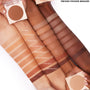ColourPop Pressed Powder Bronzer in Avila Beach swatched in even stripes across four arms of different skin tones, with open compacts in view; warm tan matte payoff shown alongside other bronzer shades for comparison.